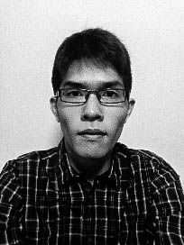 A male-presenting person in glasses, staring straight into the camera.