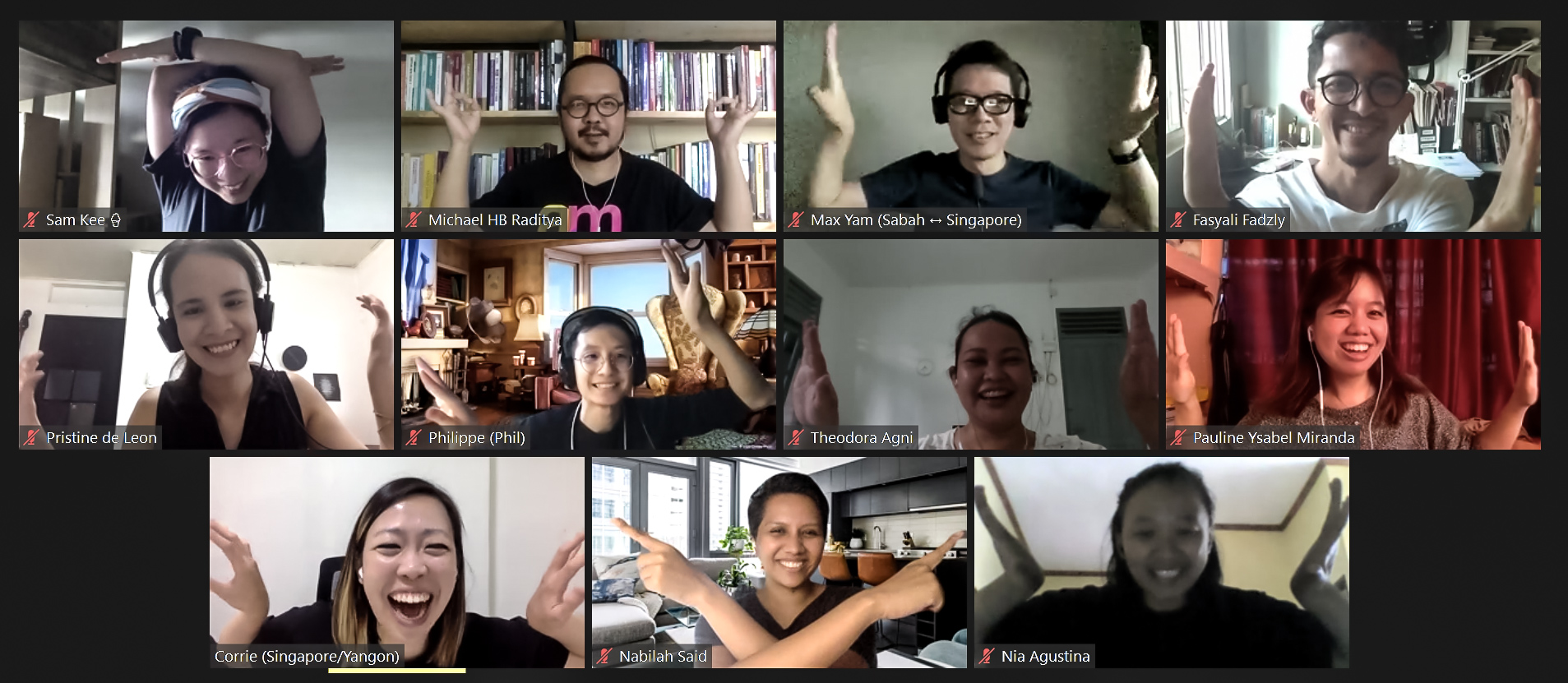 A Zoom session with eleven participants, holding their hands up in various positions.