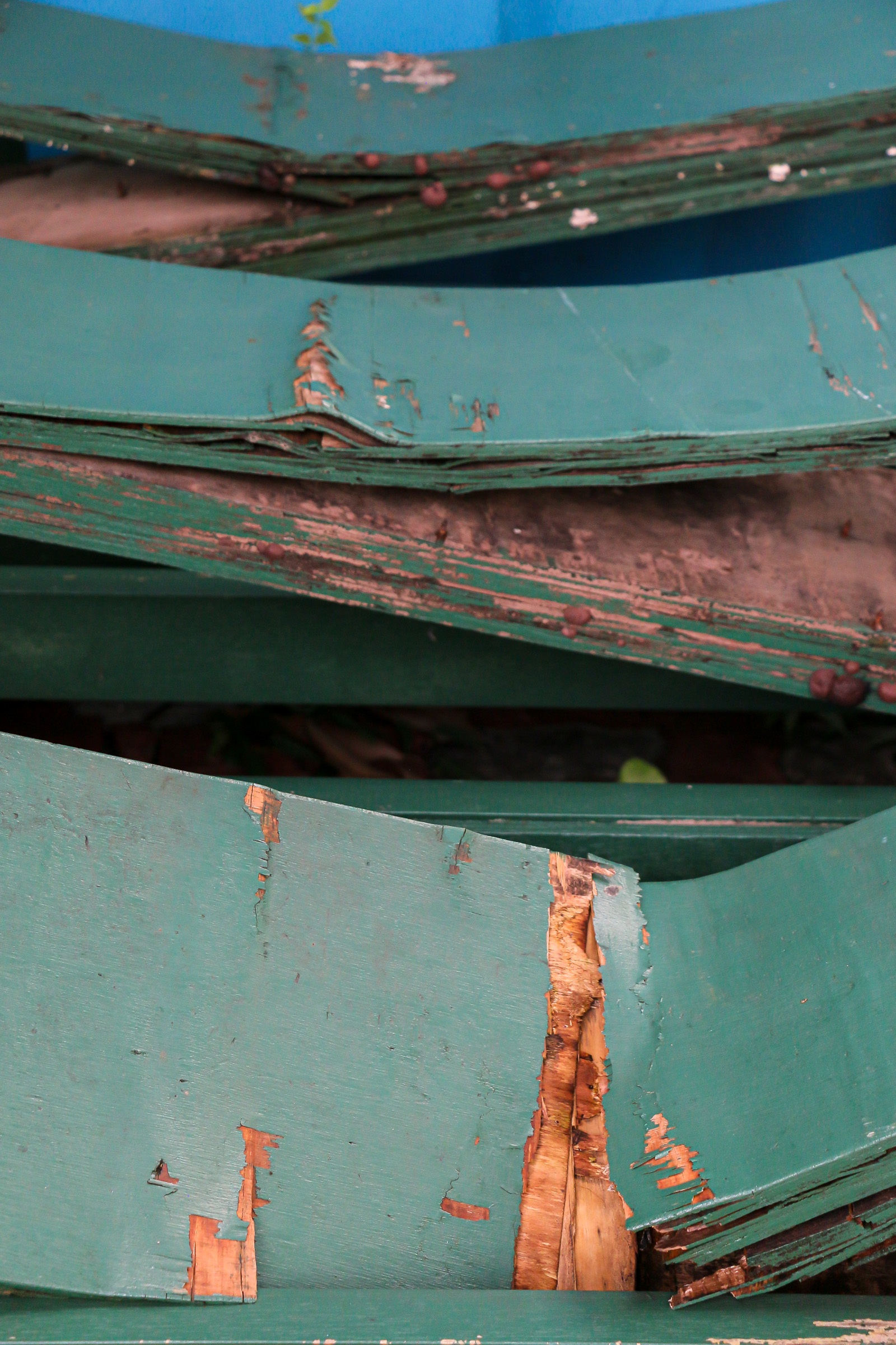 A close-up of broken green planks of wood.