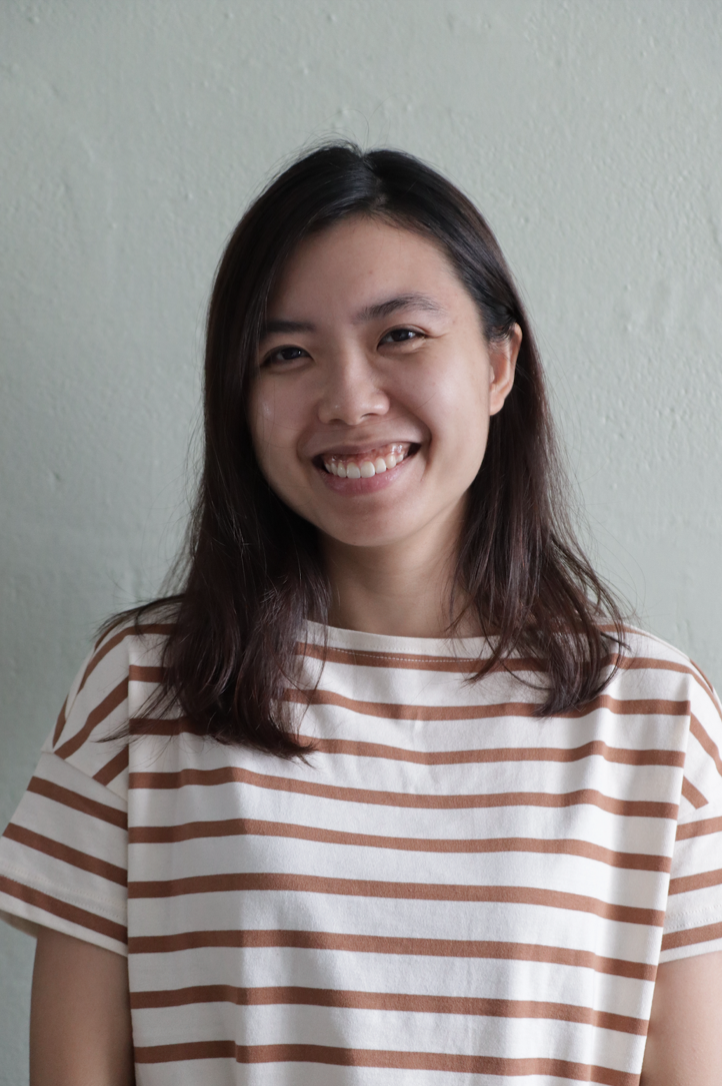 Coloured headshot of a girl in a red and white striped shirt.