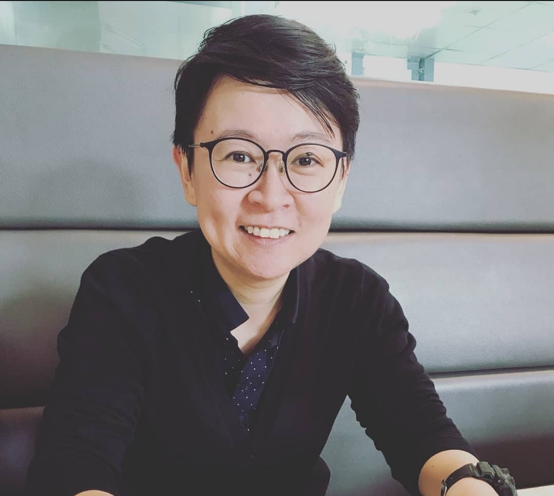 An image of Ang Hui Bin bespectacled and dressed in a black top.