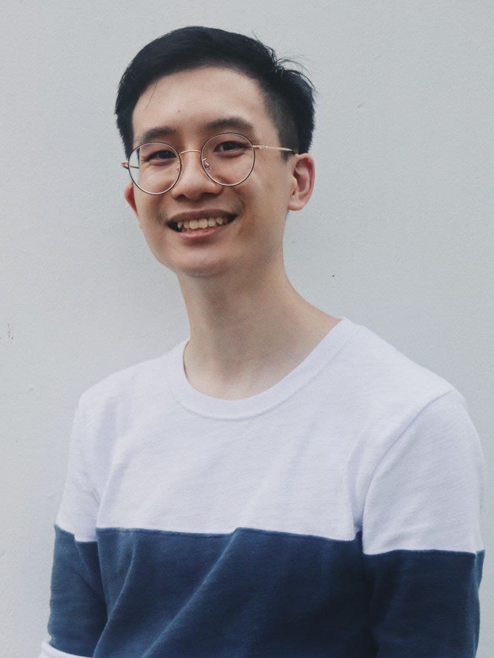 An image of Philippe Pang dressed in a striped top. 