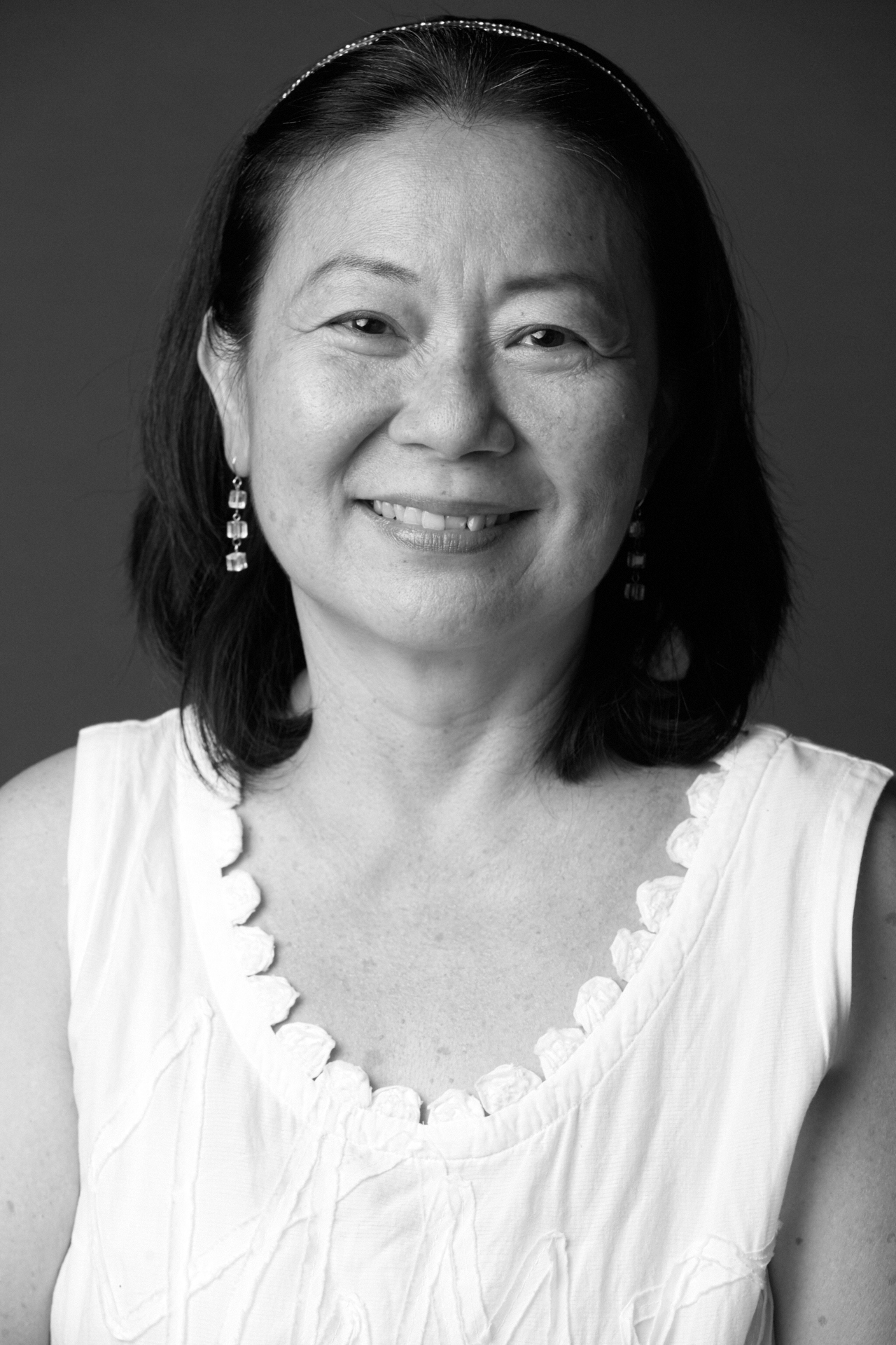 A black and white image of Neo Swee Lin, smiling and dressed in a white top.