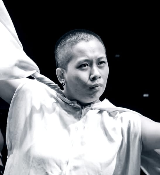 A candid stage shot of Lim Ci Xuan in black and white.