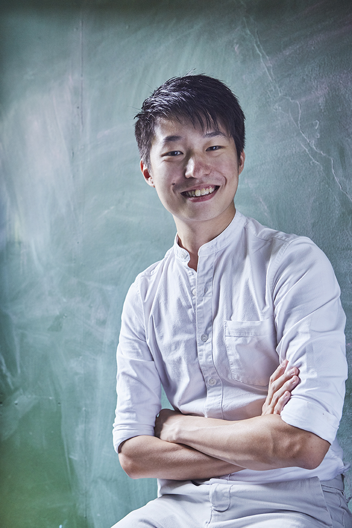 Chng Yi Kai in a white shirt with his arms folded.