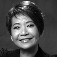 Black and white headshot of Annette Shun Wah, smiling.