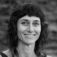 Black and white headshot of Rachael Swain, smiling.