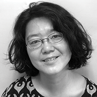 Black and white headshot of Hiromi Maruoka in glasses.