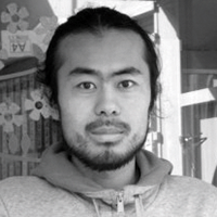 Black and white headshot of Kei Saito, wearing a hoodie.