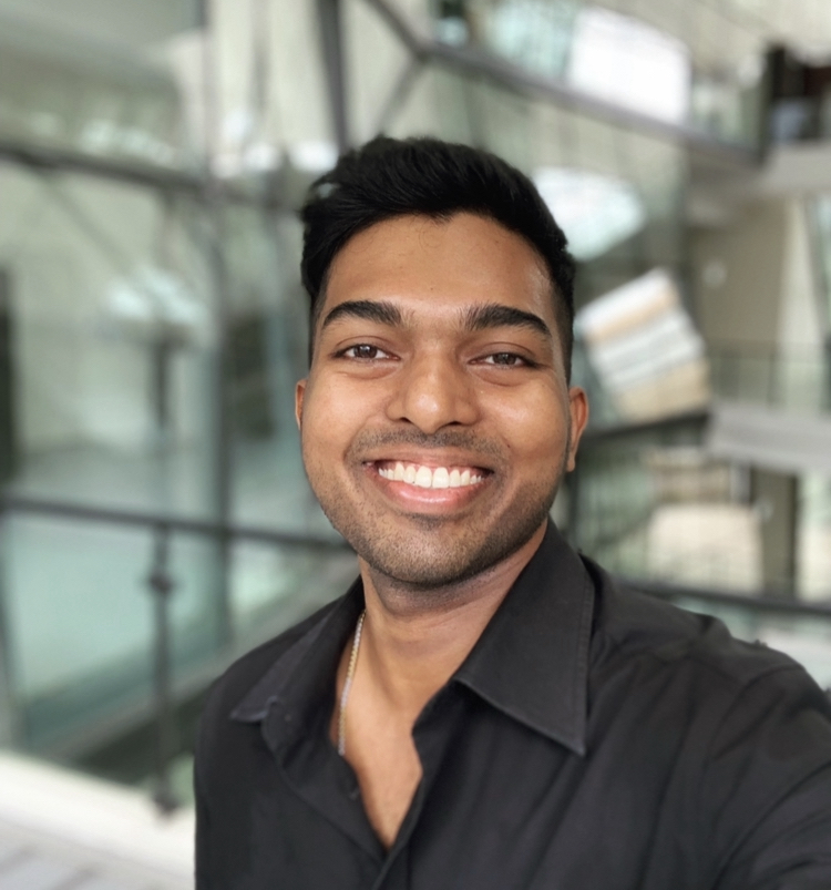 Selfie of Jaisilan Sathiasilan in a black shirt, smiling at the camera.