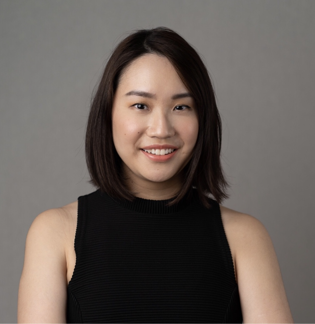 Headshot of Mary Tay in a sleeveless black top, smiling.