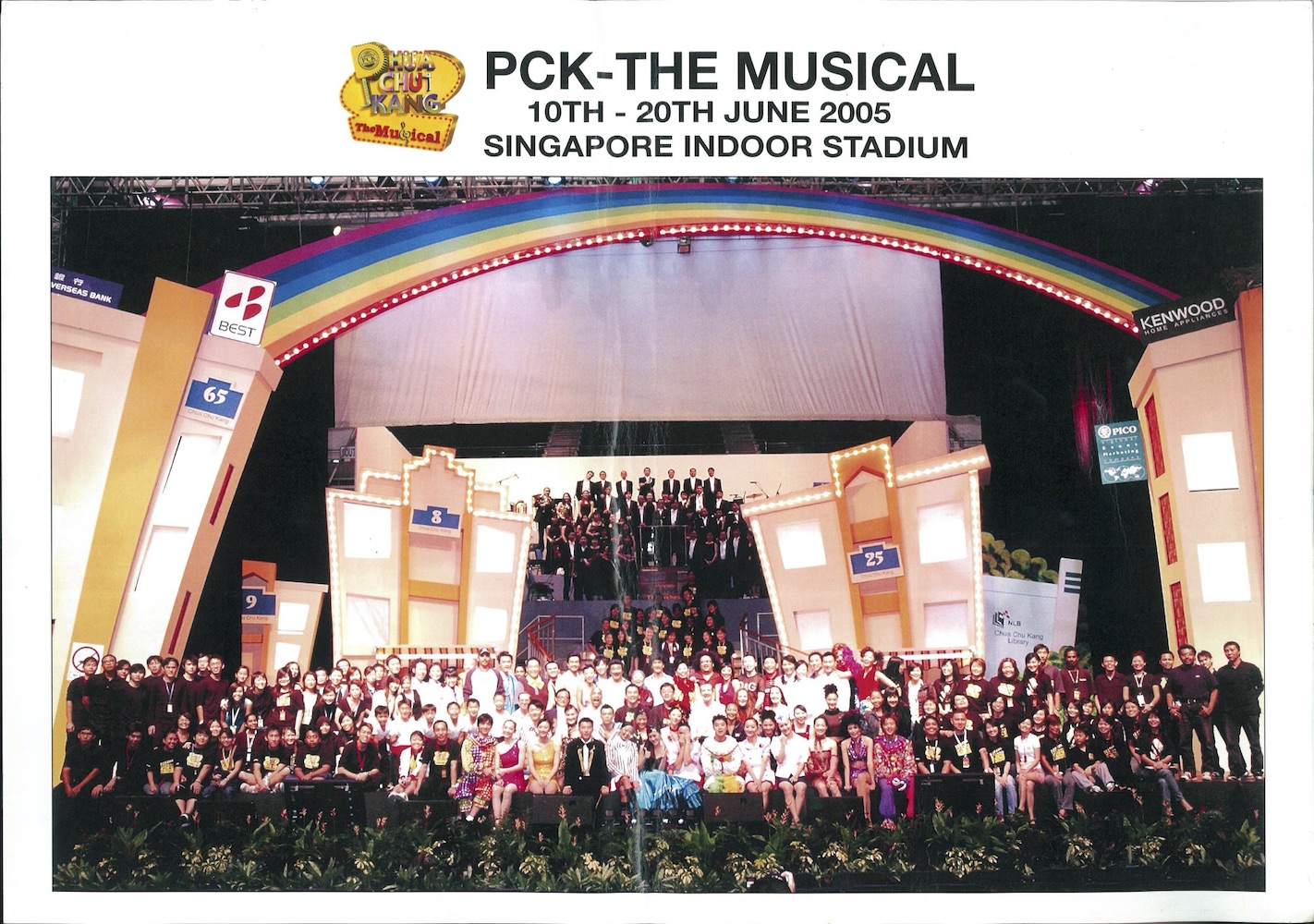 The poster features an image of the cast and crew of 'PCK The Musical' on the stage at Singapore Indoor Stadium.