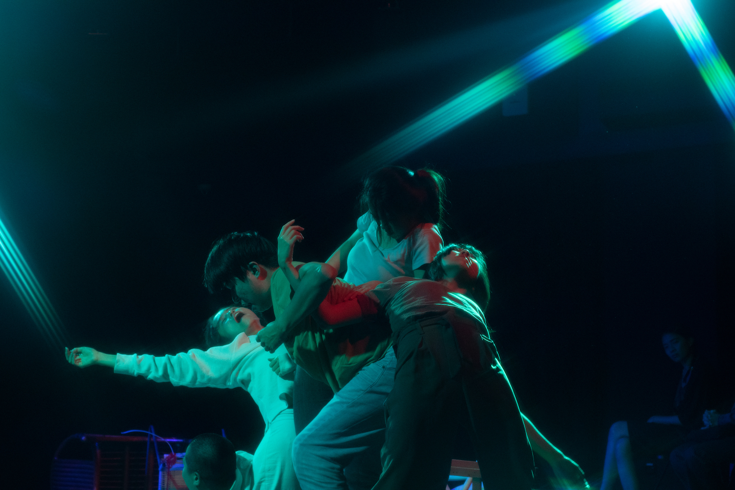 Members of ZOBO Company forming a tableaux where they are stacked on top of one another.