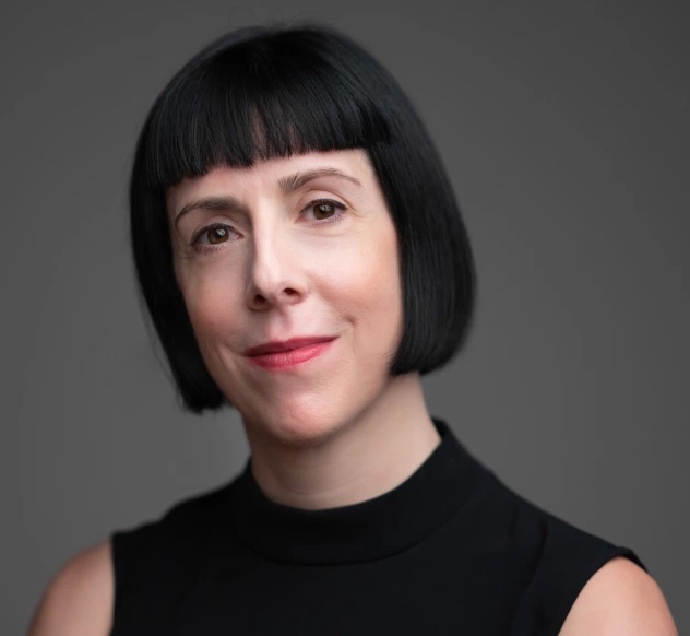 Headshot of Laura Hayes in a sleeveless black top and bob cut.