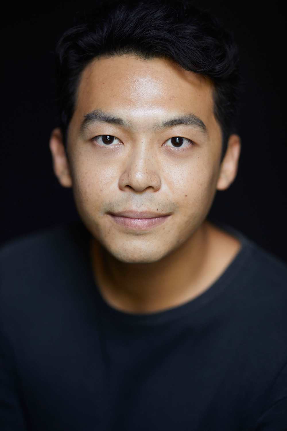 Headshot of Benjamin Chow in a blue shirt.