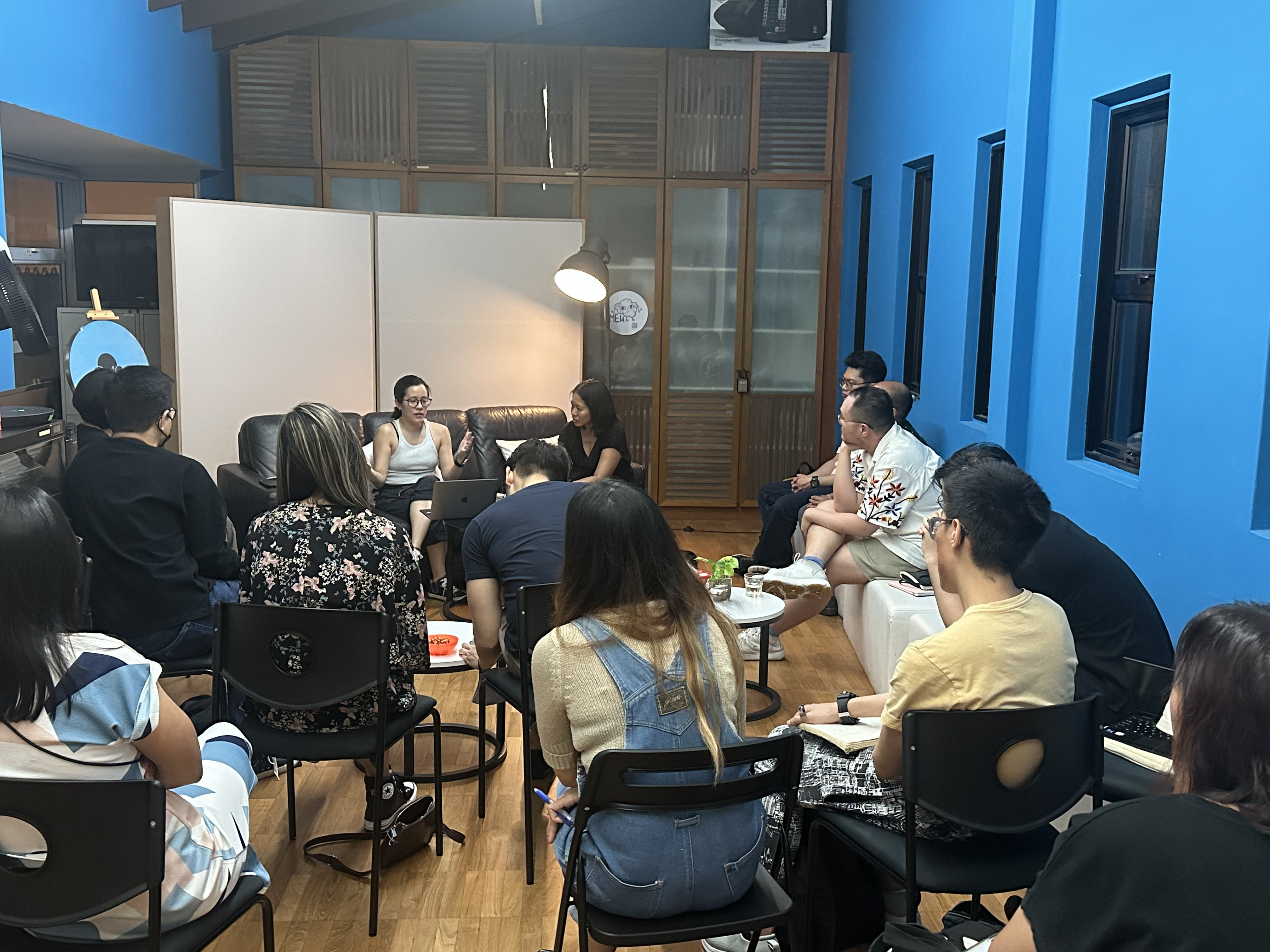 A photograph of the Centre 42 Office with attendees seated on chairs lined up in a semi-circle surrounding Michelle and Juliet in conversation.