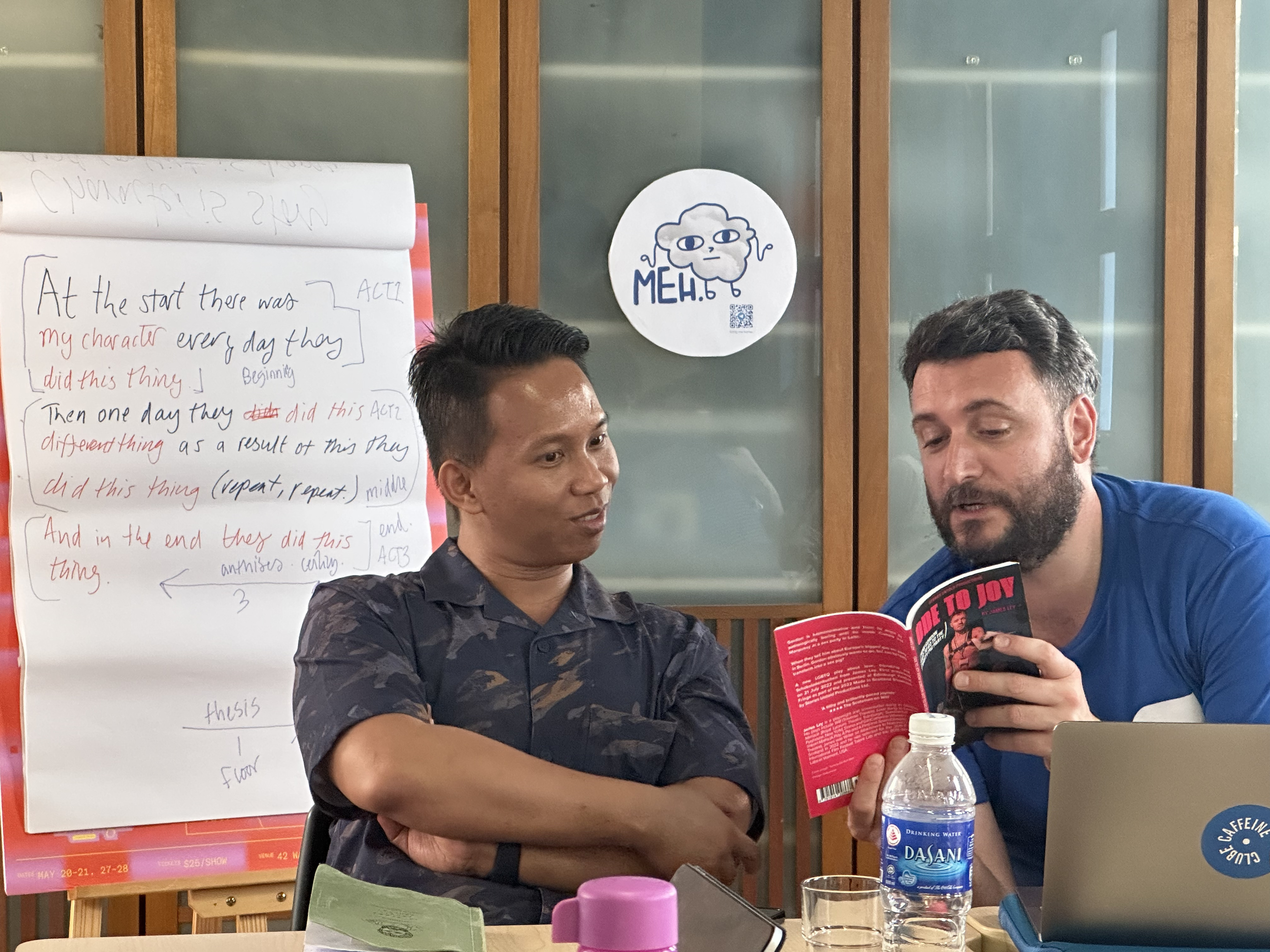 A photograph of Ahmad and James reading from "Ode to Joy".