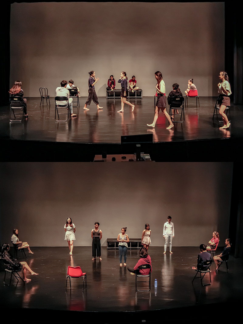 Two images, one on top of the other. Both showcase several performers on a stage. In the top image, several are seated around the stage while others walk across the stage. In the bottom image, some performers sit in a semicircle around the front of the stage while listening to five performers speak in front of them.