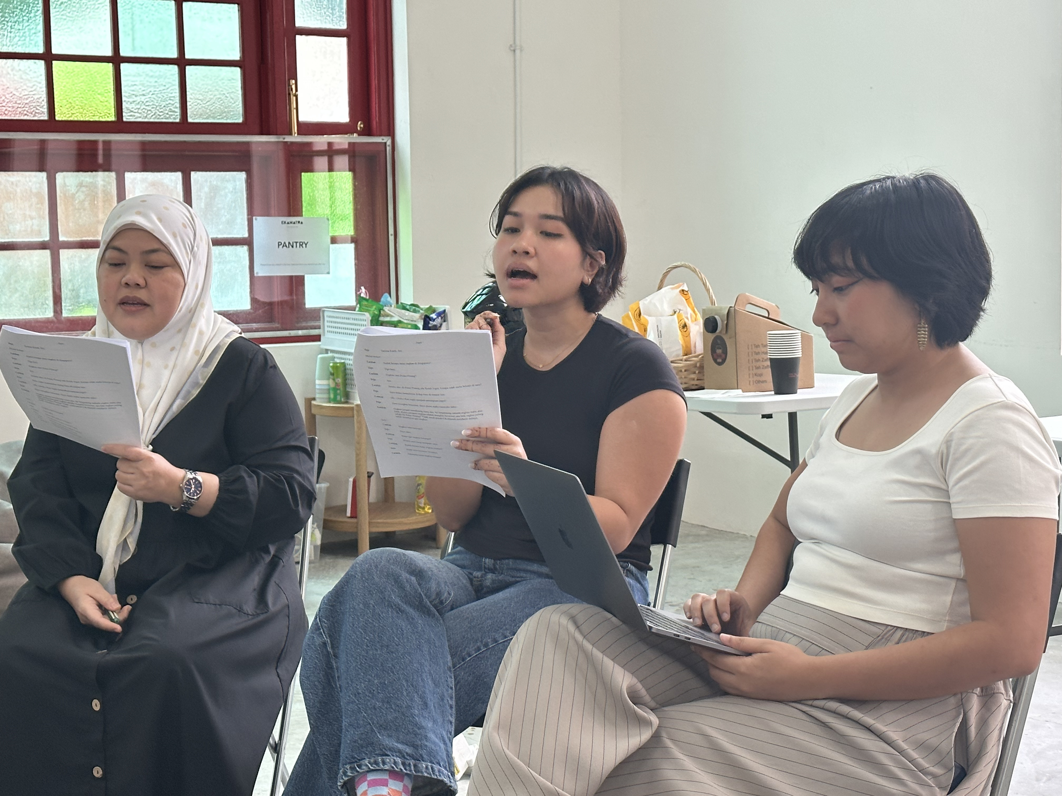 Dalifah, Farah and Tysha reading from the script.